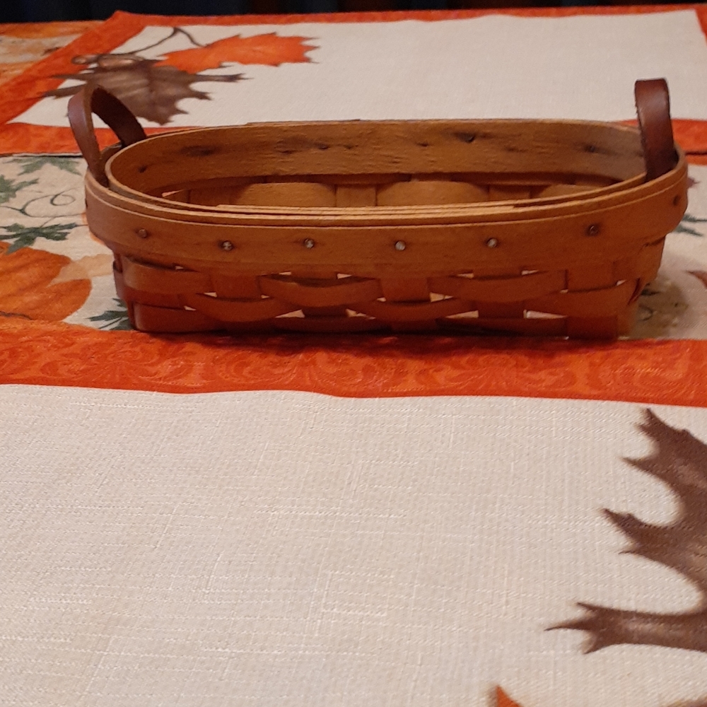Preowned small oval basket with leather handles